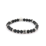 Steel bracelet with elastic inside satin black onyx spheres. Central element in patterned metal.