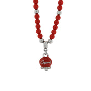 Metal necklace with hanging bell and red beads